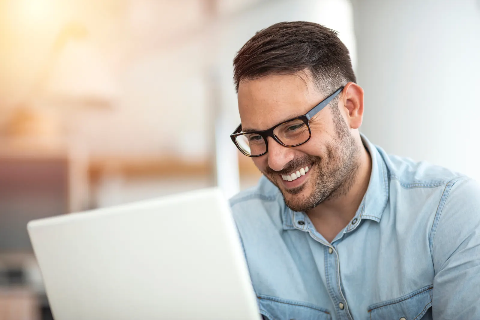 Senior executive working on a laptop in a bright modern office